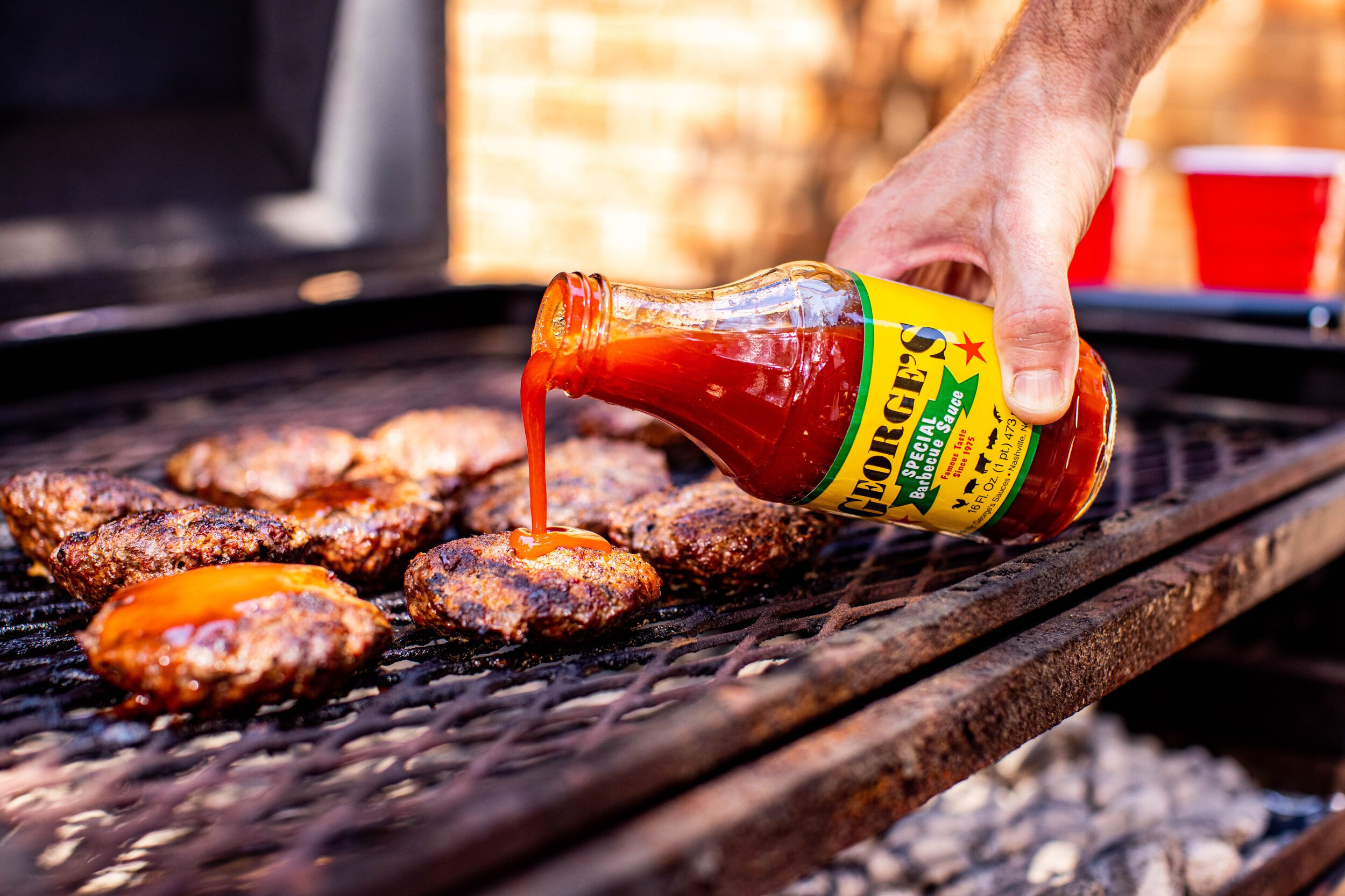 Barebones Winkel 2 Barebones Winkel -Barebones Winkel PouringGeorgesSpecialBBQSauceonBurgersonGrill